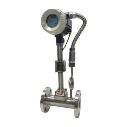 A stainless-steel vortex flow meter on a short flanged spool, with its transmitter raised on a stand and joined by armoured cable.