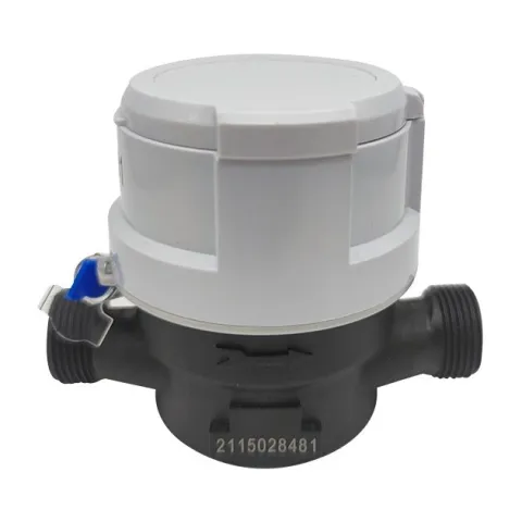 A Metrys single-jet water meter with a copper-and-glass register, lid closed, in a grey housing on a black body with a cast flow arrow.
